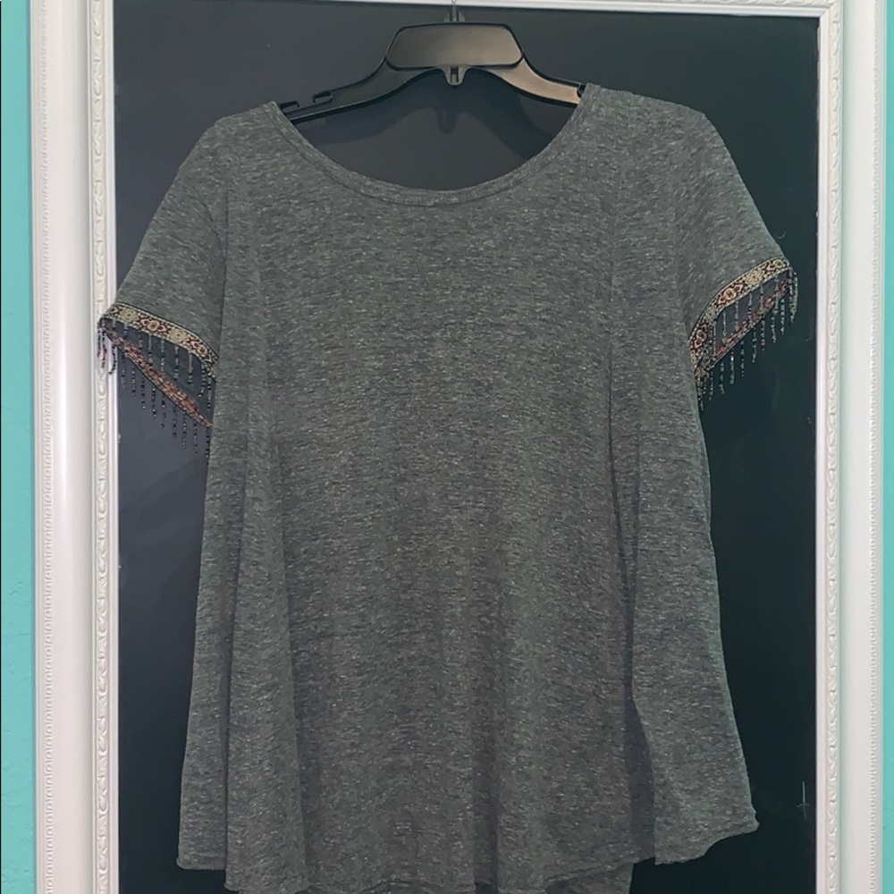 Gray tee with embroidered sleeves.